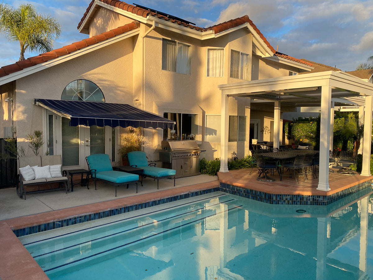 White free-standing pergola by a pool