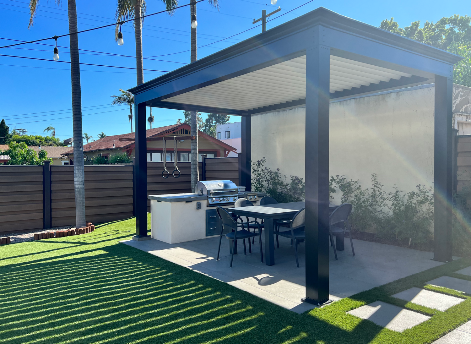 free standing luxury pergola with louvered roof with outdoor kitchen