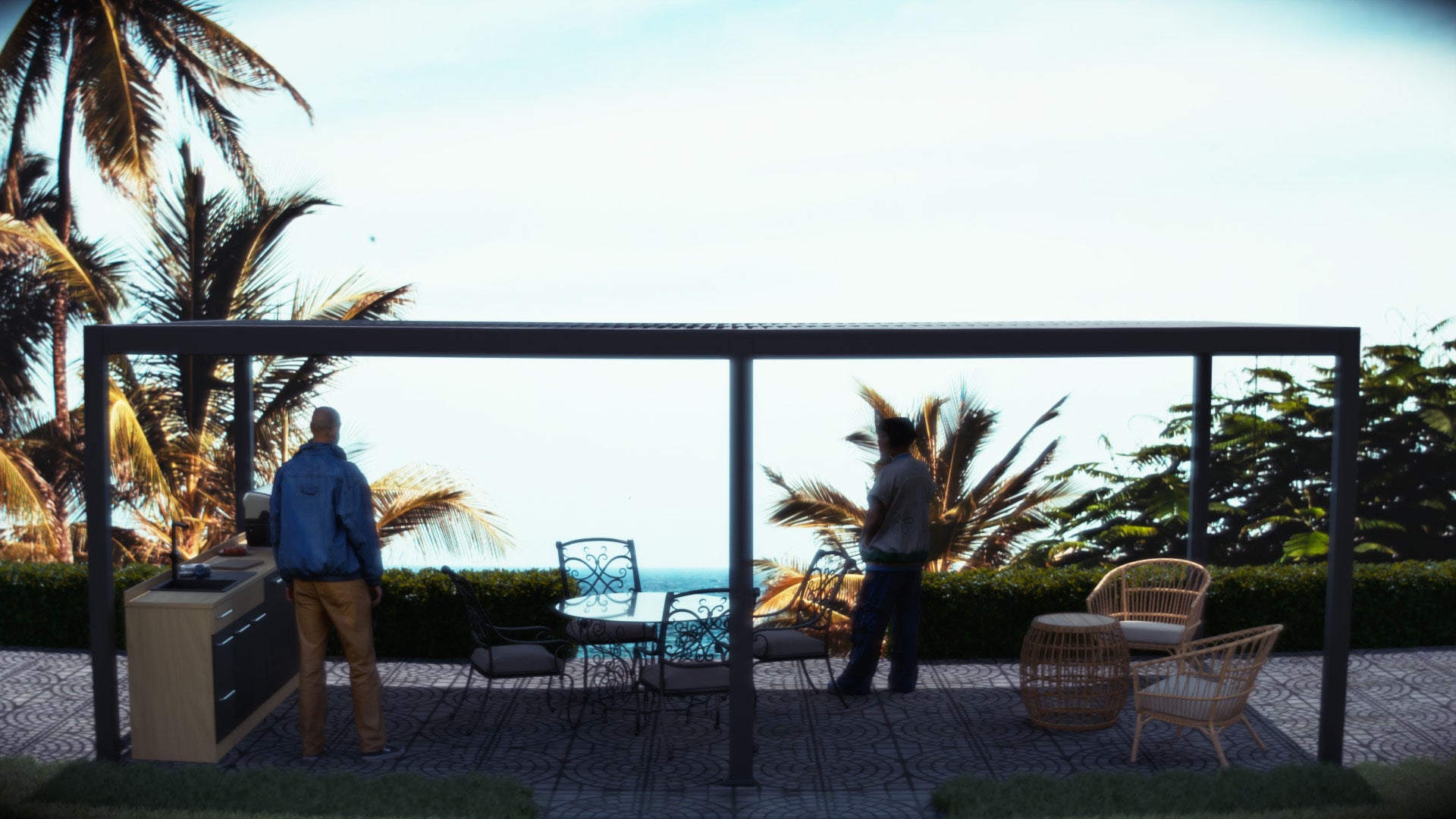 Two people standing on a patio with a scenic view of palm trees and the ocean.