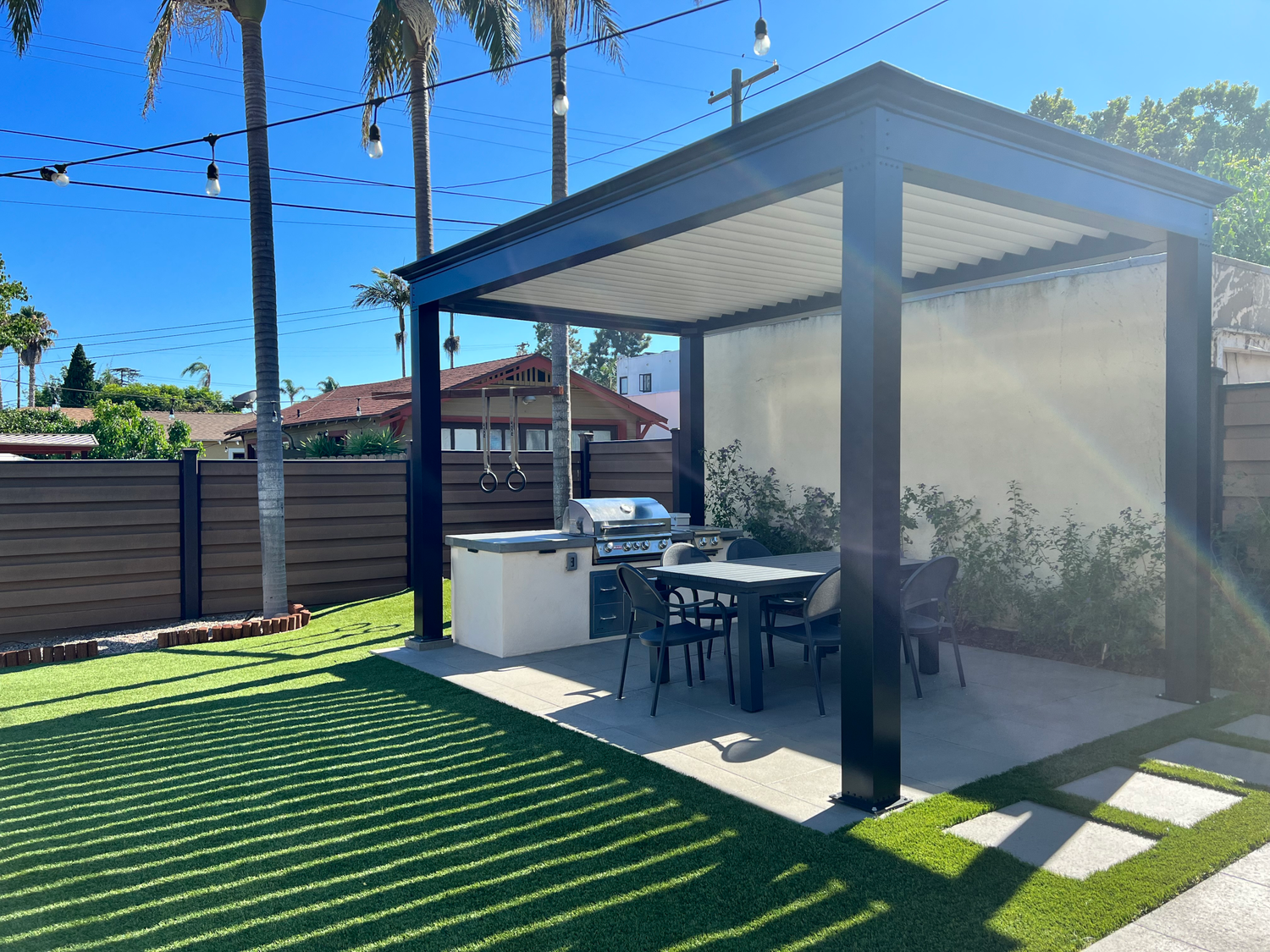 free standing luxury pergola with louvered roof and outdoor kitchen