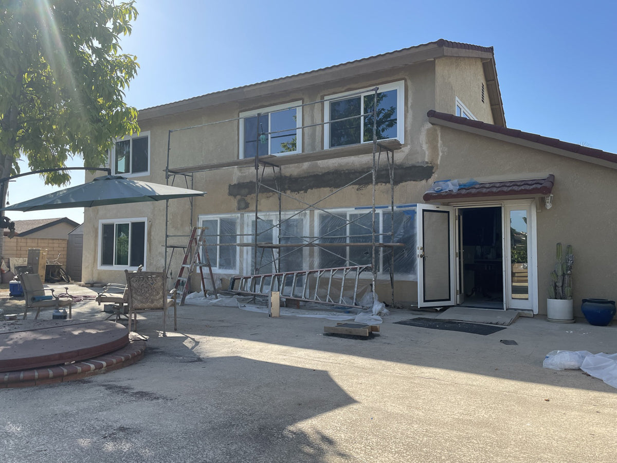 house attached pergola structure under construction in an outdoor living space