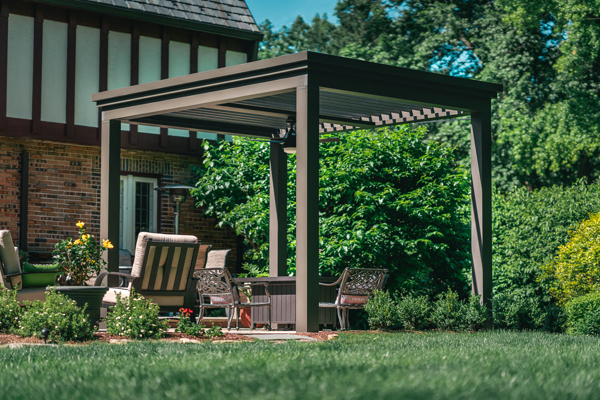 free standing bronze louvered pergola in a backyard living space