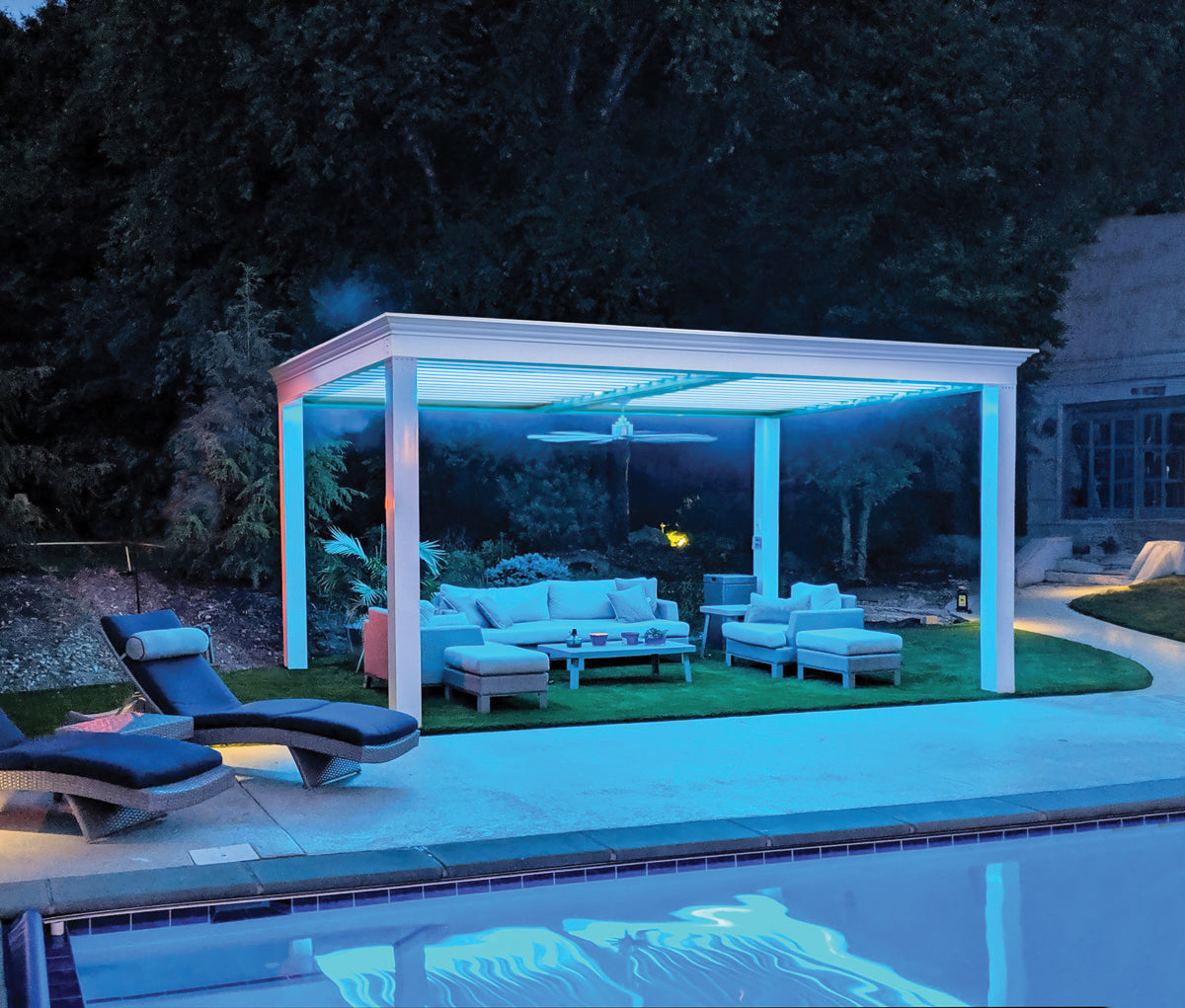 white poolside pergola structure with lighting and fan attached