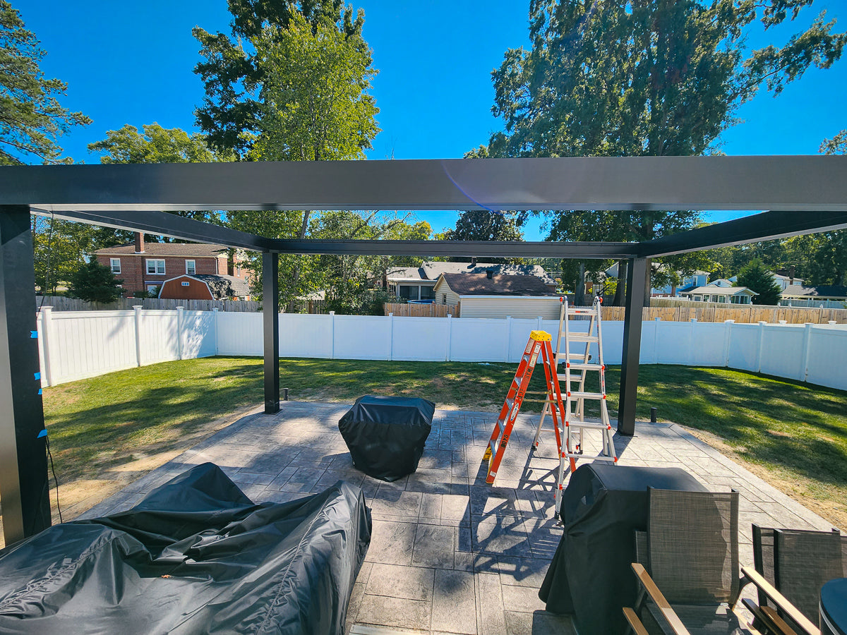 black aluminum pergola structure being assembled