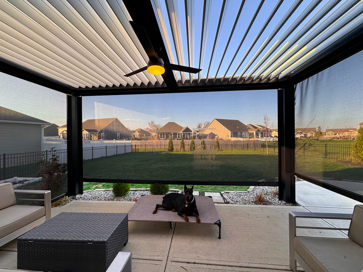 luxury pergola with black frame and stone colored louvered roof attache to home with smart shades