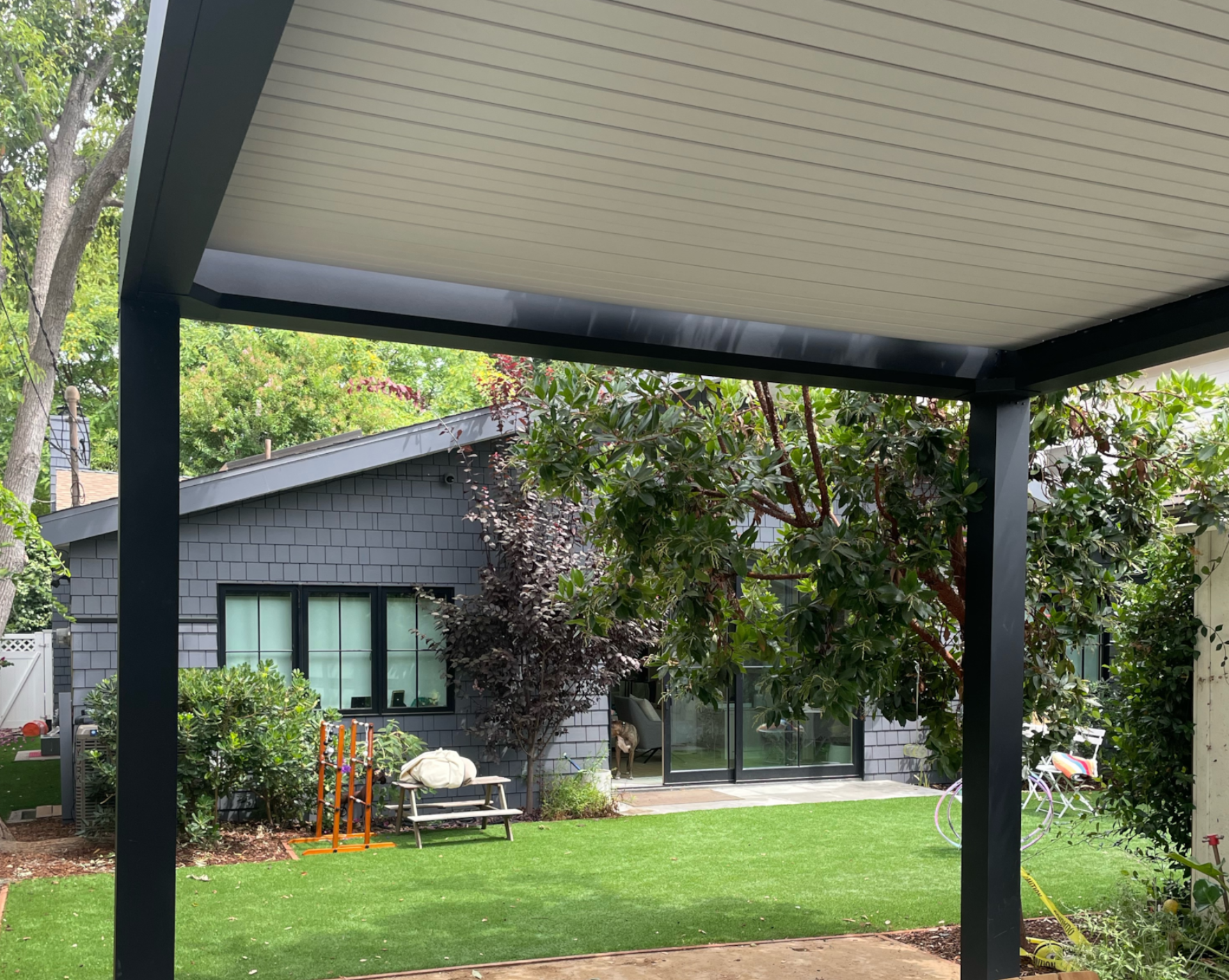 black backyard pergola on patio