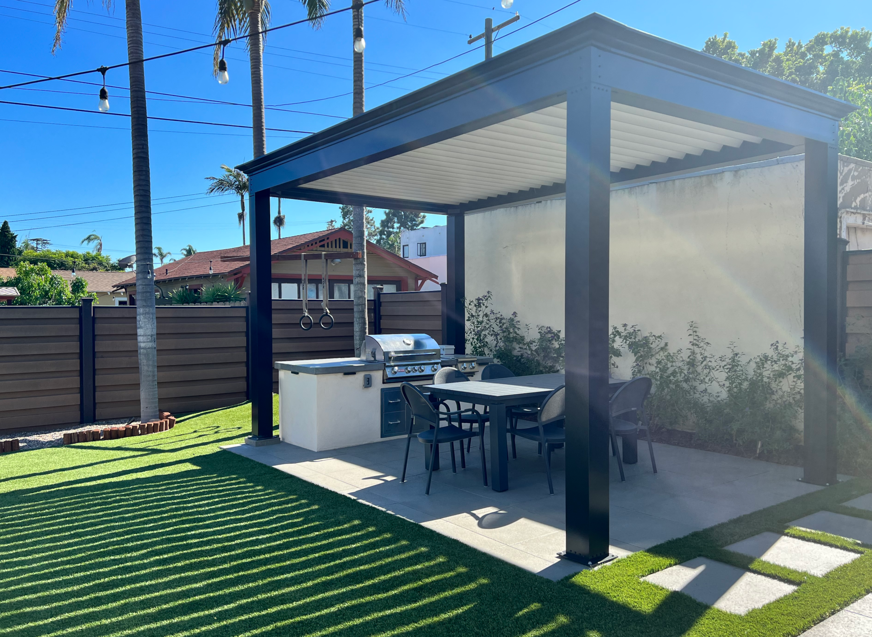 free standing luxury pergola with louvered roof and outdoor kitchen