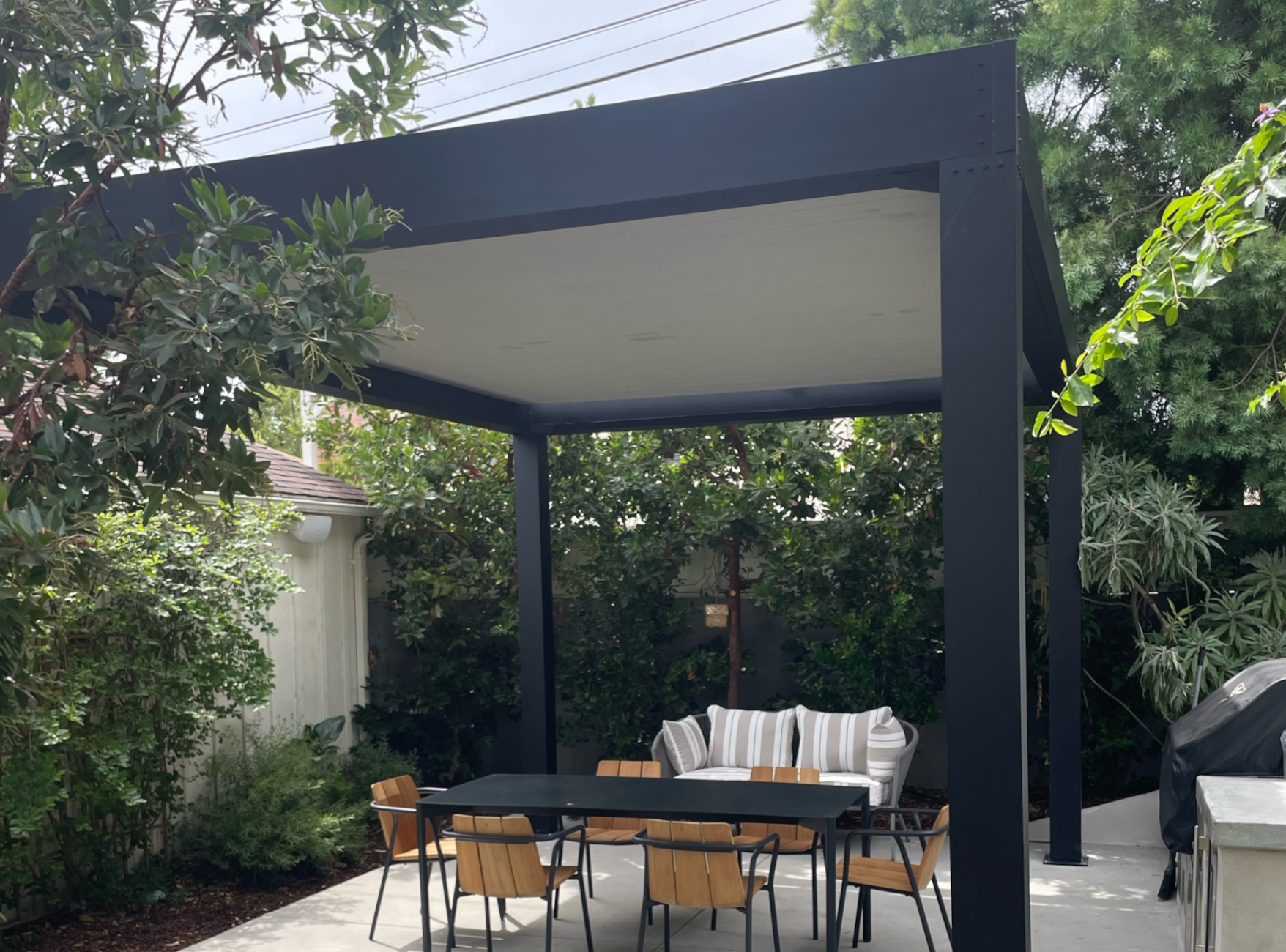 free standing luxury pergola with louvered roof dining area