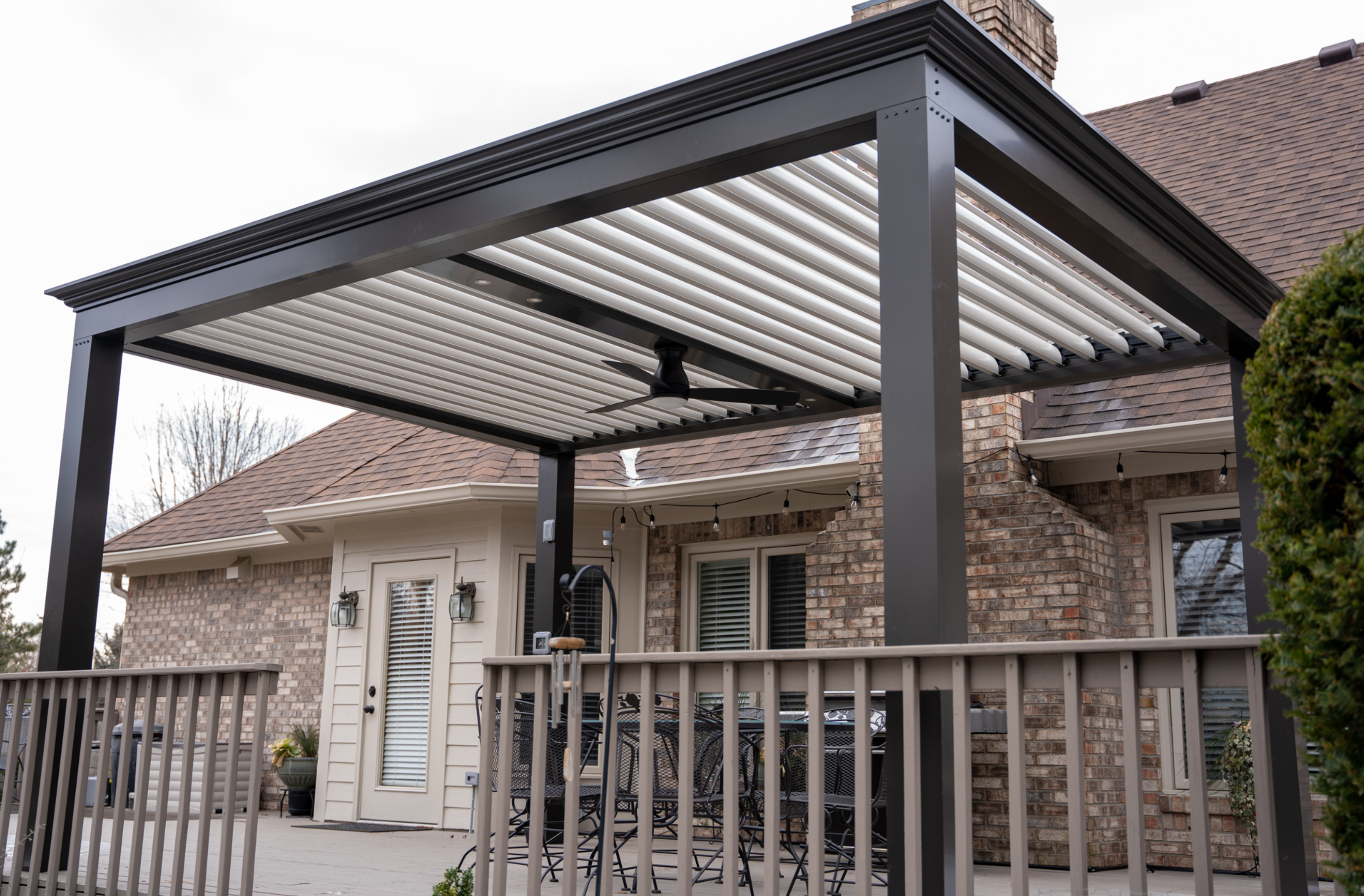 free standing luxury pergola with louvered roof on a deck