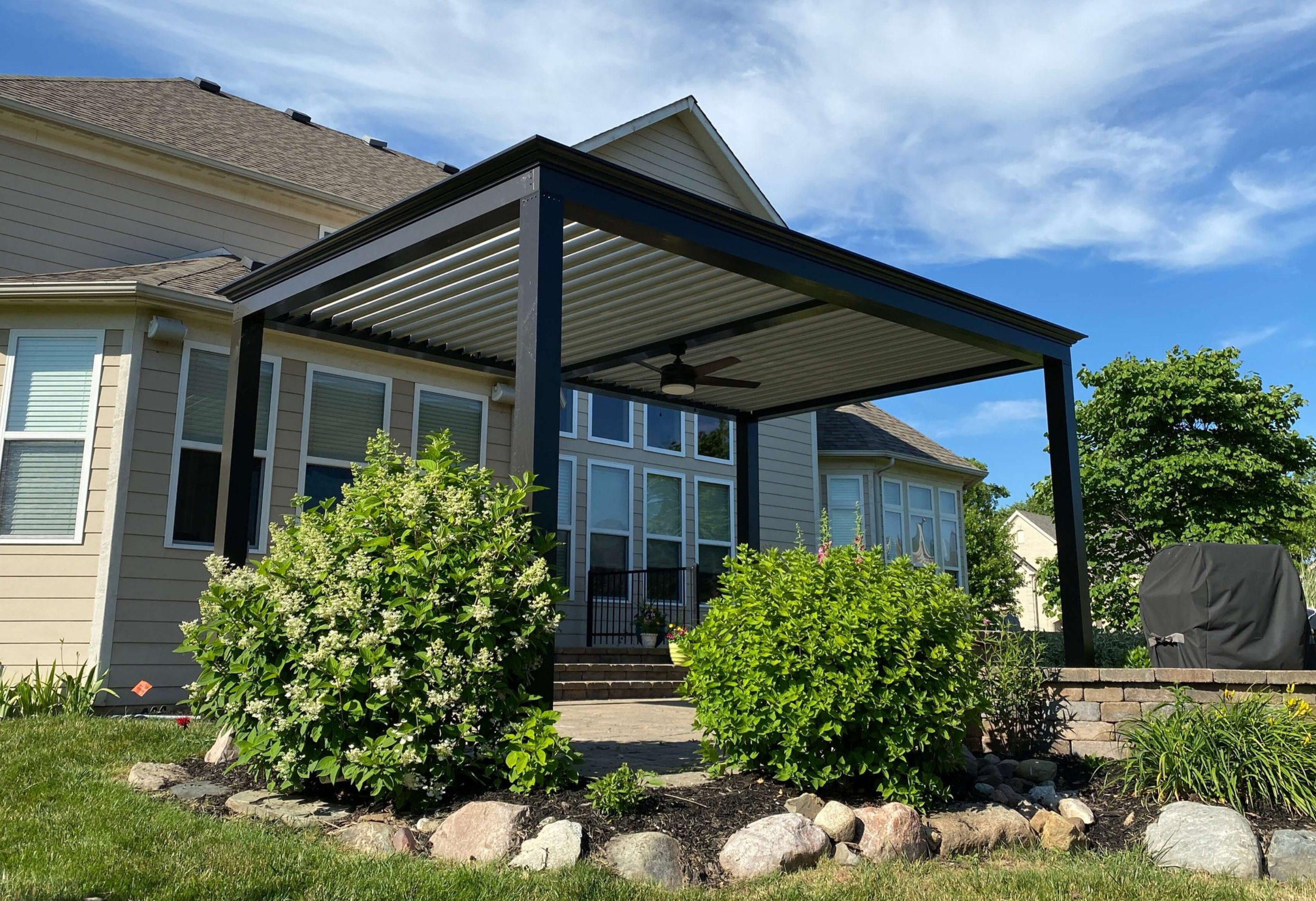 free standing luxury pergola with louvered roof on deck