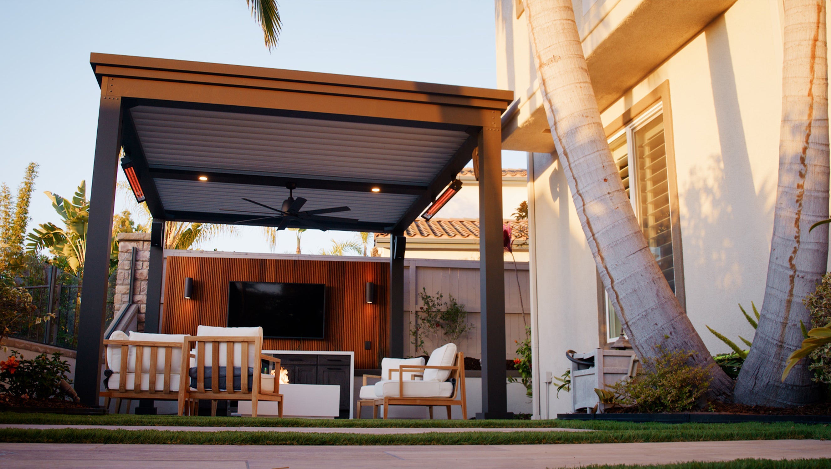 outdoor living space with luxury pergola, outdoor seating, privacy wall and TV!