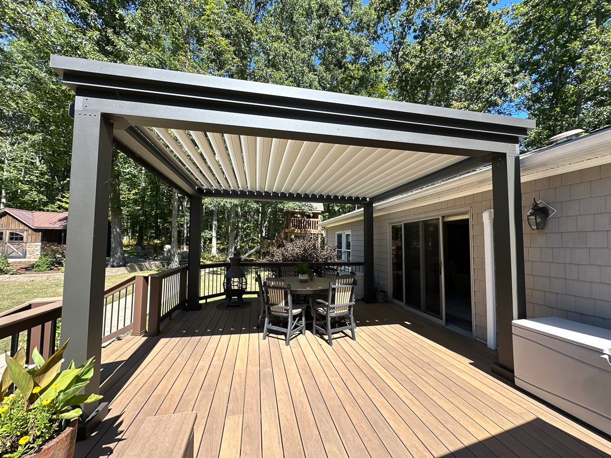 free standing black louvered roof pergola on patio in backyard living space