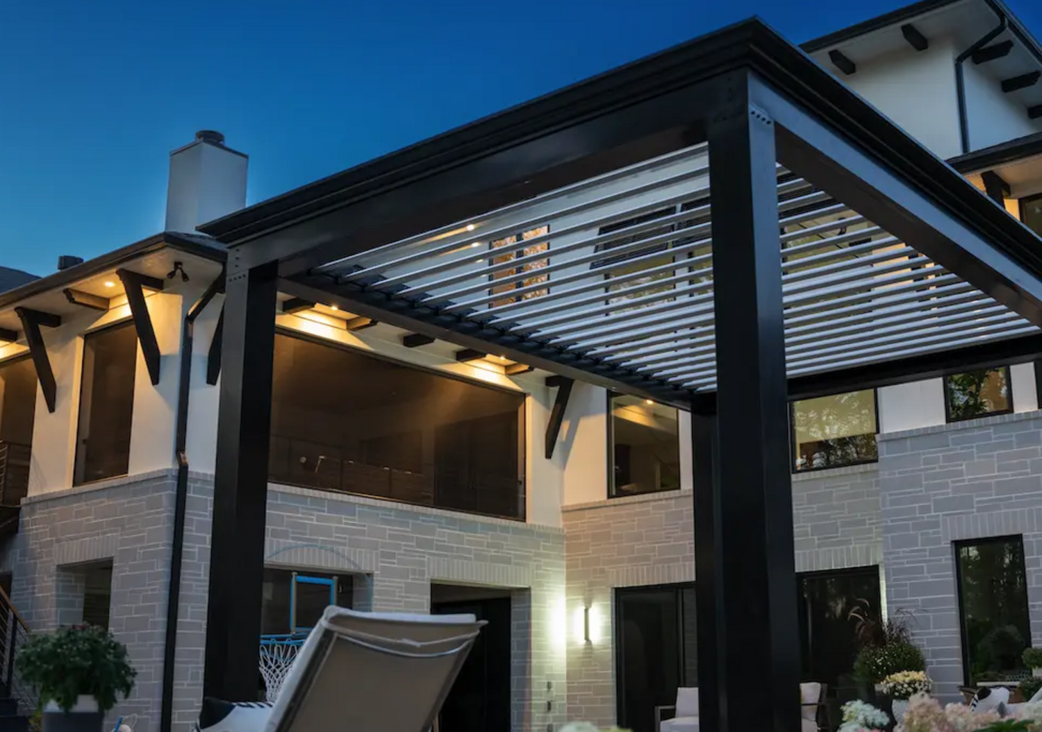 free standing luxury pergola with louvered roof at night