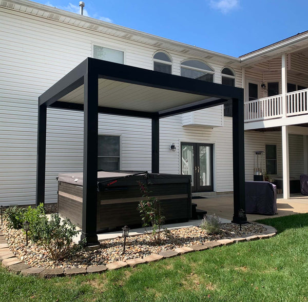 Black pergola with planter boxes attached to home