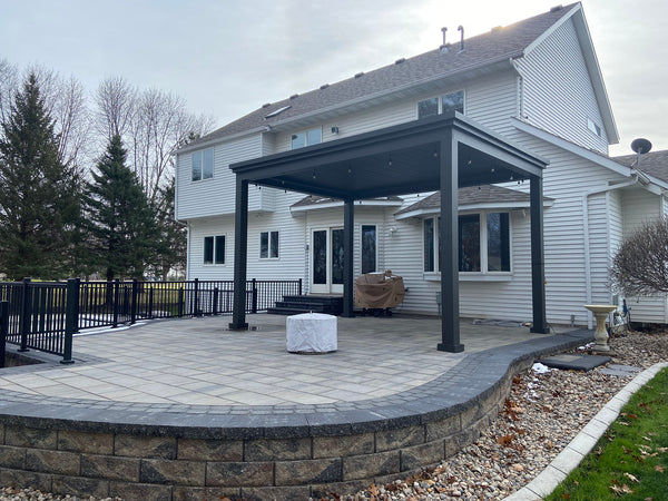 Gray aluminum louvered pergola over patio lounge seating