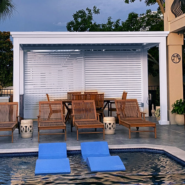 Modern white louvered pergola with adjustable blinds above pool with blue loungers