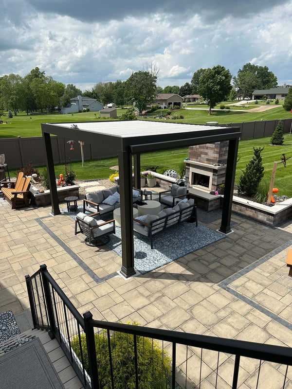 Black pergola with white louvers over patio